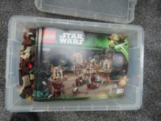 A box containing Lego Star Wars Ewok Village Set 10236 with the three instruction booklets