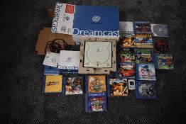 A Sega Dreamcast Console and controller, both boxed along with games including MSR, F1 World Grand