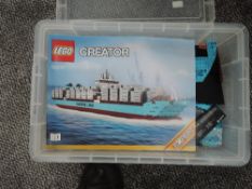 A box containing Lego Creator Maersk Ship with Cargo Set 10241 with two instruction booklets