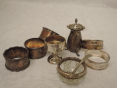 A selection of HM silver including five napkin rings of various forms, cut glass salt, pepperette
