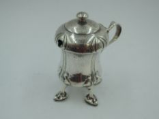 An Edwardian Arts & Crafts Cymric silver mustard pot designed by Archibald Knox for Liberty & Co