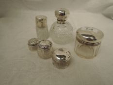 A cut glass spherical scent bottle having silver lid monogrammed G and glass stopper, London 1911, a