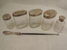 Five cut glass dressing table pots and bottles having HM silver lids and an HM silver handled button