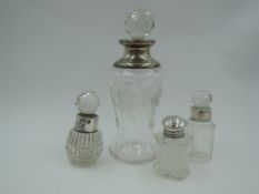 An etched glass perfume bottle having floral swag decoration, cut glass stopper and silver collar,