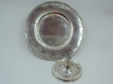 An Edwardian silver saucer of plain circular form having decorative rim, Birmingham 1906, T