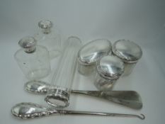 Six glass dressing table pots and bottles of assorted shapes having HM silver lids, and a matching