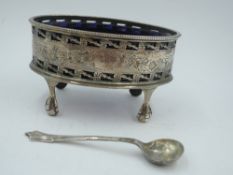 A Victorian silver salt of oval form having pierced and engraved swag decoration, plain cartouche,