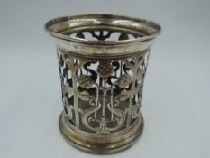 An Edwardian silver bottle/jar holder of cylindrical form (missing glass liner) having Art Nouveau