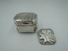 A small silver trinket box having engine turned decoration and plain cartouche to hinged lid and