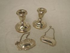A pair of small HM silver candle sticks of squat form having weighted bases and two HM silver