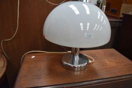 A vintage style table lamp, mushroom style with opaque shade and chrome frame