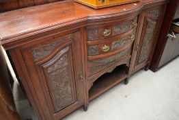 A 19th Century mahogany sideboard having semi bow front drawer centre section and carved detailing ,