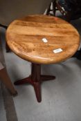 A vintage Singer sewing machine stool having wooden seat and painted cast base