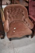 A Victorian low seat arm chair having button back dralon upholstery