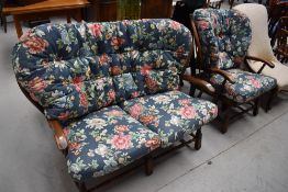 A vintage Ercol or similar cottage suite having foliate cushions