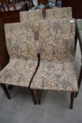 A set of four vintage dining chairs having medieval style upholstery