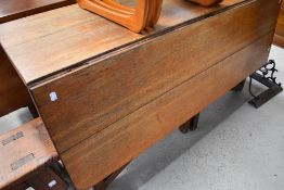 A 19th Century oak dining table having single drop leaf, with drawer to end
