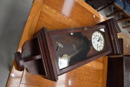 A late 20th Century reproduction wall clock in the 19th Century style having mahogany effect case,