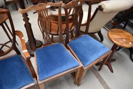 A pair of early 20th Century mahogany dining chairs having later blue dralon upholstered drop in