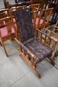 A late Victorian spindle frame American style rocking chair