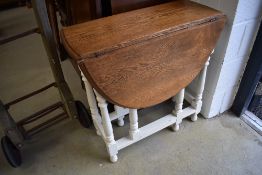 An early 20th Century oak gateleg table having painted frame
