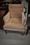 A late 19th or early 20th Century low seat armchair having button seat and back