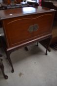 A reproduction cocktail cabinet on cabriole legs
