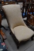 A 19th Century mahogany scroll frame nursing chair having scroll frame and late upholstery
