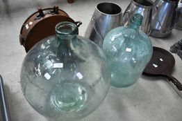 A vintage carboy and similar glass vessel