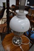 A 'Famos' oil lamp with chimney and shade, converted to electric