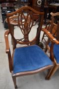 An early 20th Century mahogany frame carver chair having shield back with typical sheraton style