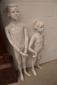 A pair of shop mannequins, childrens size, in distressed condition but complete