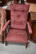 A late Victorian spindle frame recliner arm chair