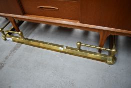 An adjustable brass fire fender