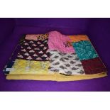 A hand made patchwork quilt or fabric throw