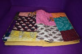 A hand made patchwork quilt or fabric throw