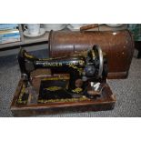 A crank handled Singer sewing machine, serial number F8690956.