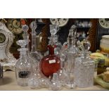 A large collection of vintage decanters, stoppers and similar.