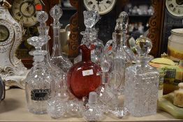 A large collection of vintage decanters, stoppers and similar.