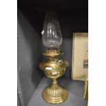 A Victorian oil burning lamp having decorative base by Youngs De Lite