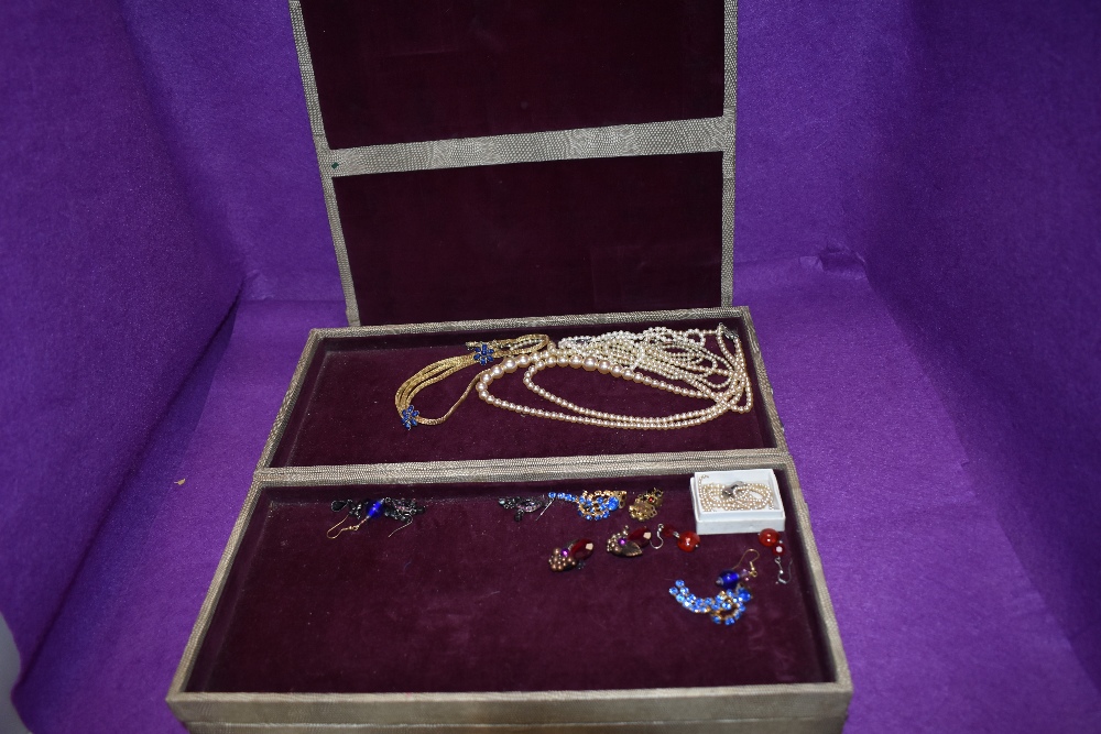 A large vintage jewellery travel case of concertina form containing a small selection of costume