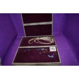 A large vintage jewellery travel case of concertina form containing a small selection of costume
