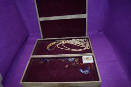 A large vintage jewellery travel case of concertina form containing a small selection of costume