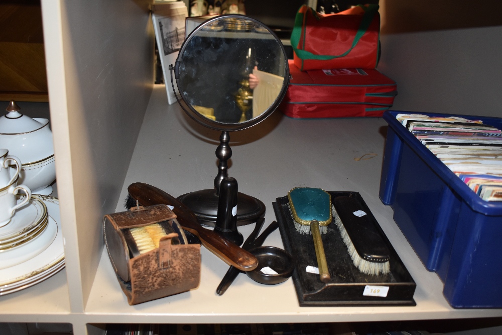 A selection of Ebony dressing table items including a brush set and shaving mirror