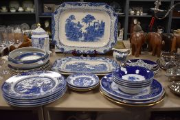 A selection of blue and white ware including Old Willow, platters, bowls, plates and more included.