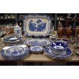 A selection of blue and white ware including Old Willow, platters, bowls, plates and more included.