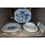 A selection of vintage and antique platters including blue and white ware.