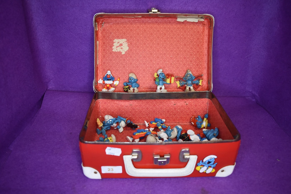 A selection of collectable toy Smurf figures including 70's 80's and 90's eras and red Smurf style