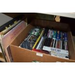 A box full of compact discs and DVDs and a small amount of LPs, something for everyone!