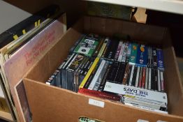 A box full of compact discs and DVDs and a small amount of LPs, something for everyone!